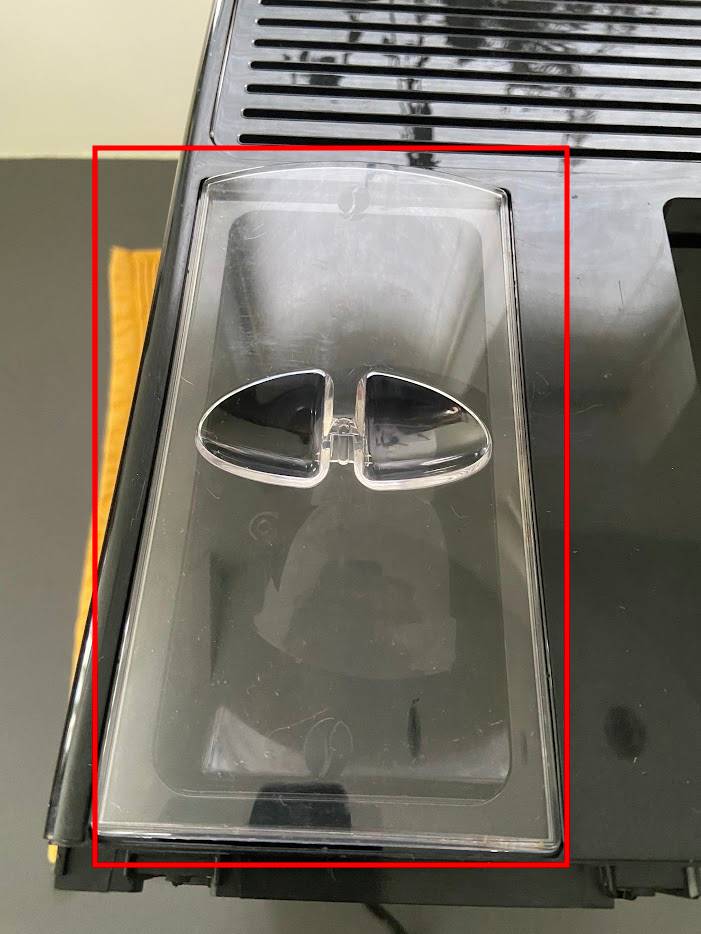 Verwijder afdekkap koffiereservoir